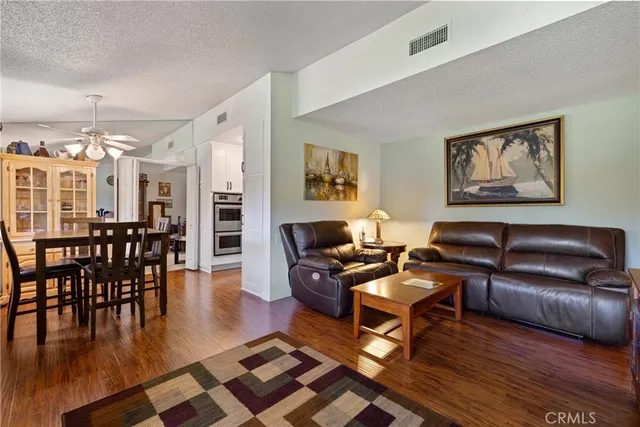 a kitchen with granite countertop cabinets stainless steel appliances and a stove