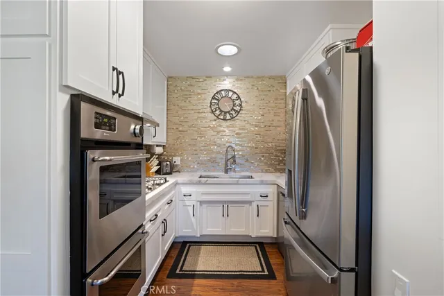 a kitchen with a refrigerator and a sink