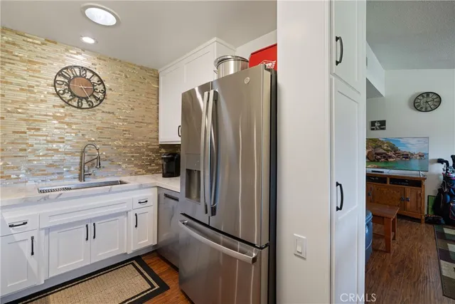 a kitchen with granite countertop a stove and a refrigerator