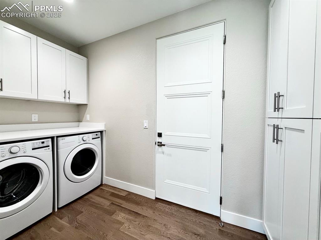 3135 Promise Point Colorado Springs, CO 80921 - Photo 13 of 33 Washroom featuring cabinet space, dark wood finished floors, and washing machine and dryer