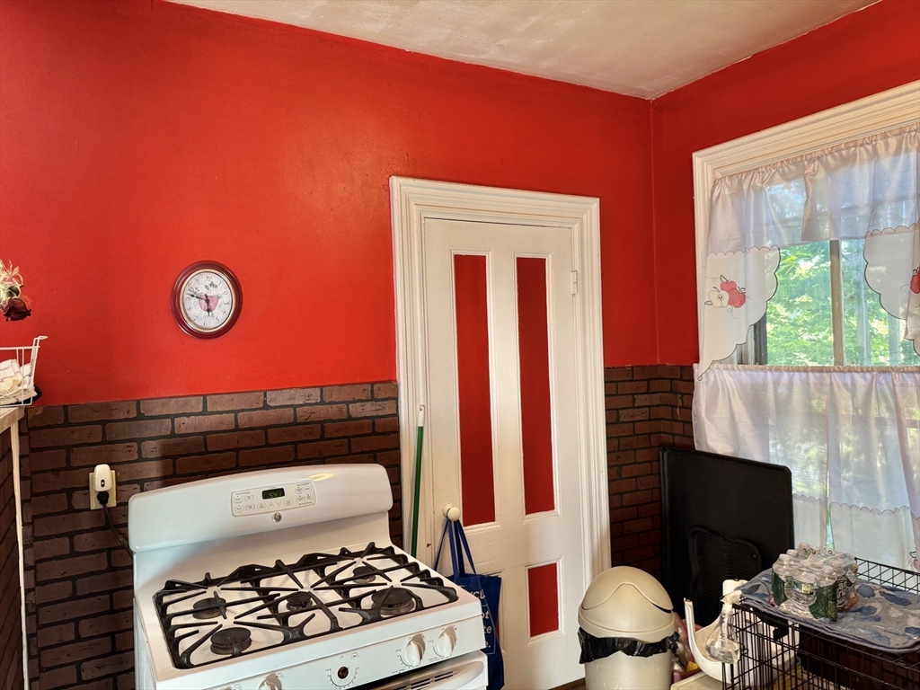 495 Warren Street Boston, MA 02121 - Photo 4 of 25 a room with furniture and a fireplace