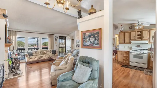 a living room with furniture and a kitchen view