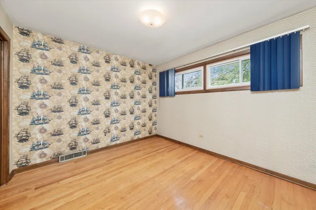 a view of an empty room with a window and closet