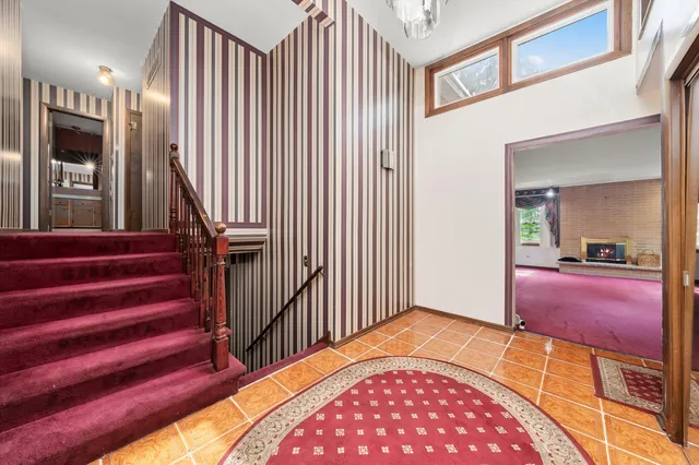 a view of a livingroom with furniture and staircase