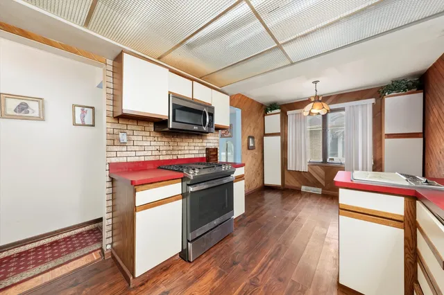a kitchen with a stove a sink and a refrigerator