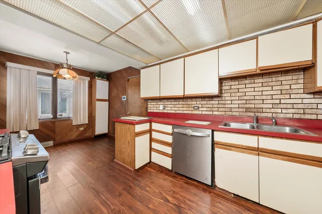 a kitchen with stainless steel appliances granite countertop a sink stove and wooden floor