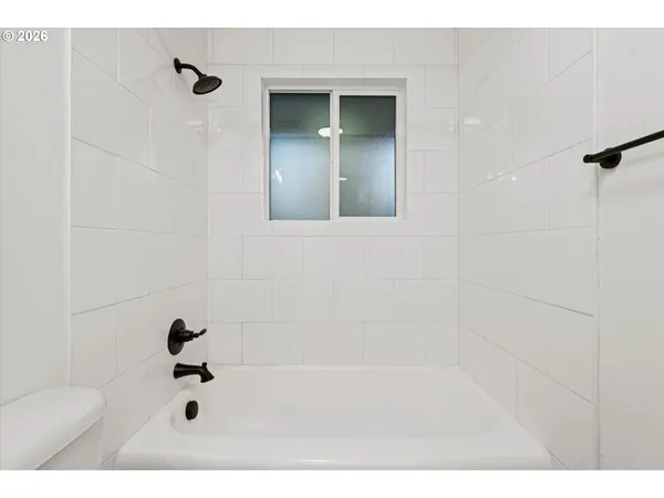 a bathroom with a bathtub and shower