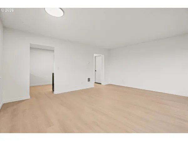 a view of an empty room and wooden floor
