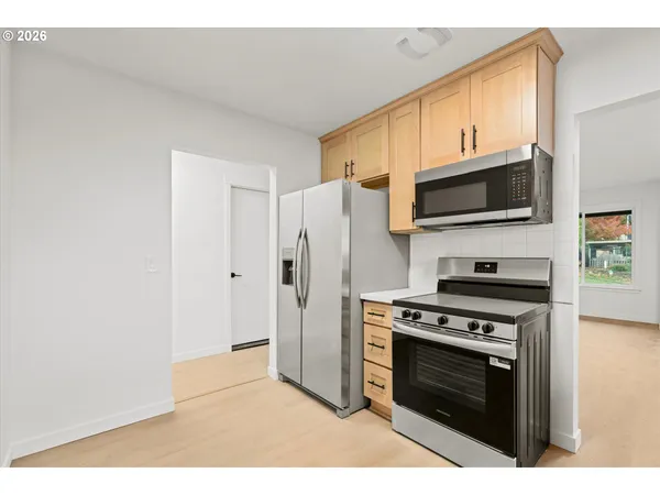 a kitchen with a stove and a microwave
