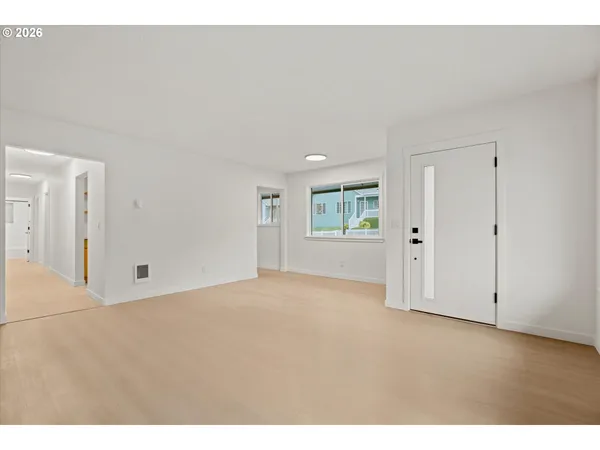 a view of an empty room and a window