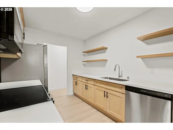 a kitchen with a sink and refrigerator