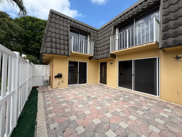 a view of a house with wooden fence