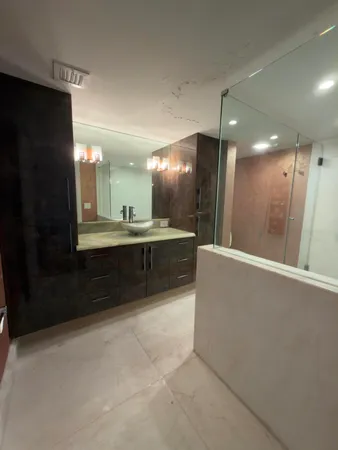 a view of a bathroom with a sink and mirror