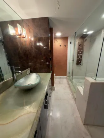 a bathroom with a double vanity sink a large mirror and shower