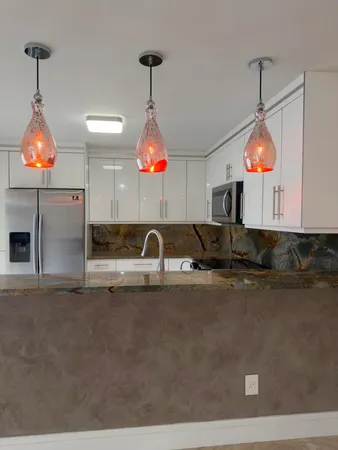 a kitchen with a sink and chandelier