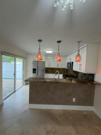 a living room with furniture a chandelier and a flat screen tv