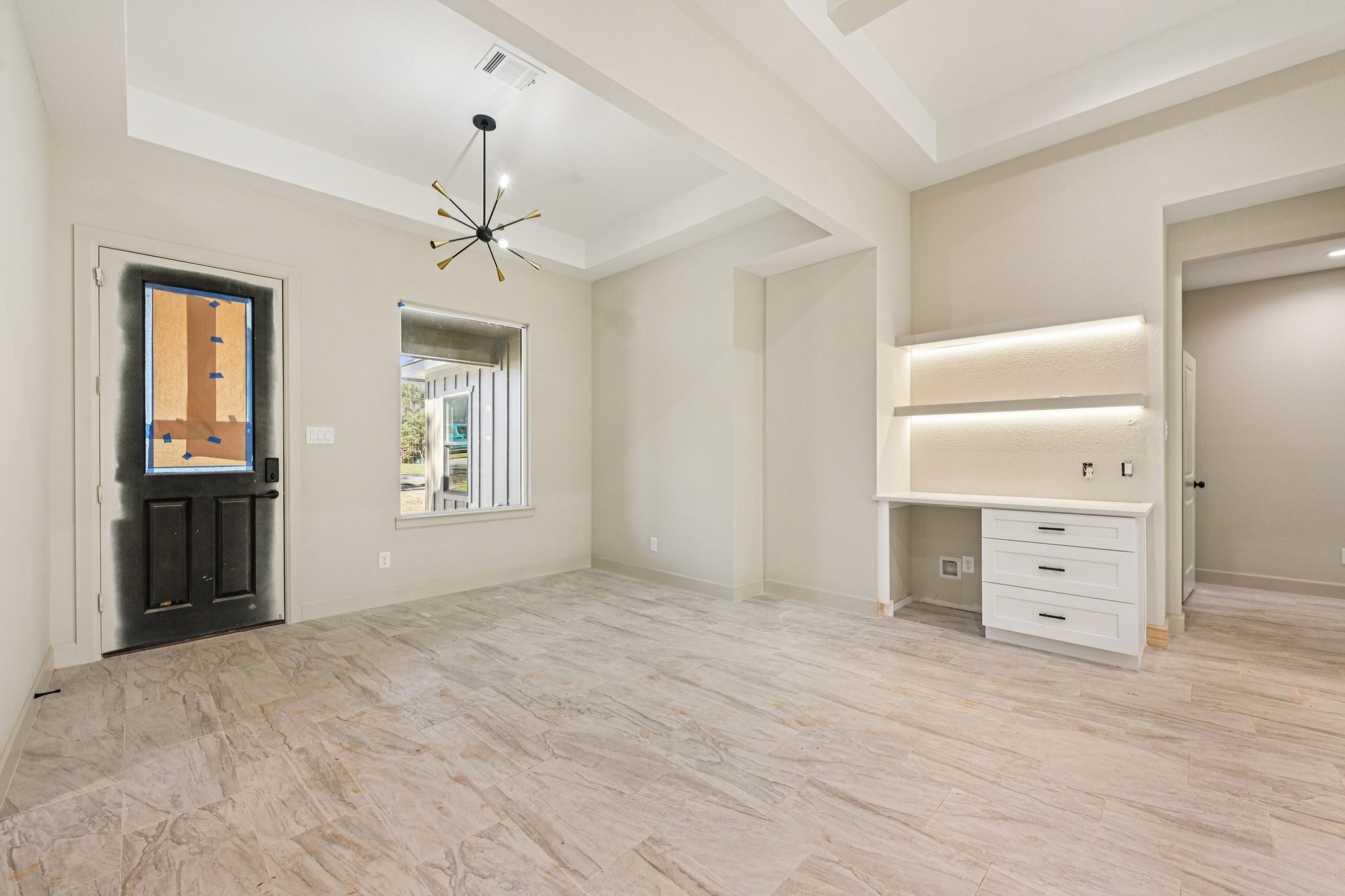 15132 Coaltown Road Willis, TX 77378 - Photo 9 of 29 The space features a charming coffee station, a built-in desk with shelves, and a window that brings in beautiful natural light.
