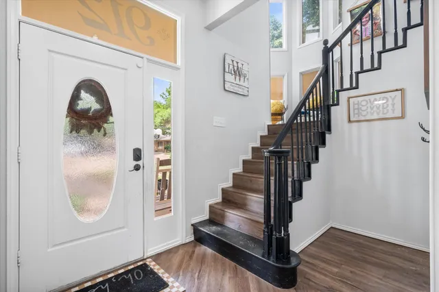 a view of entryway and hall with wooden floor