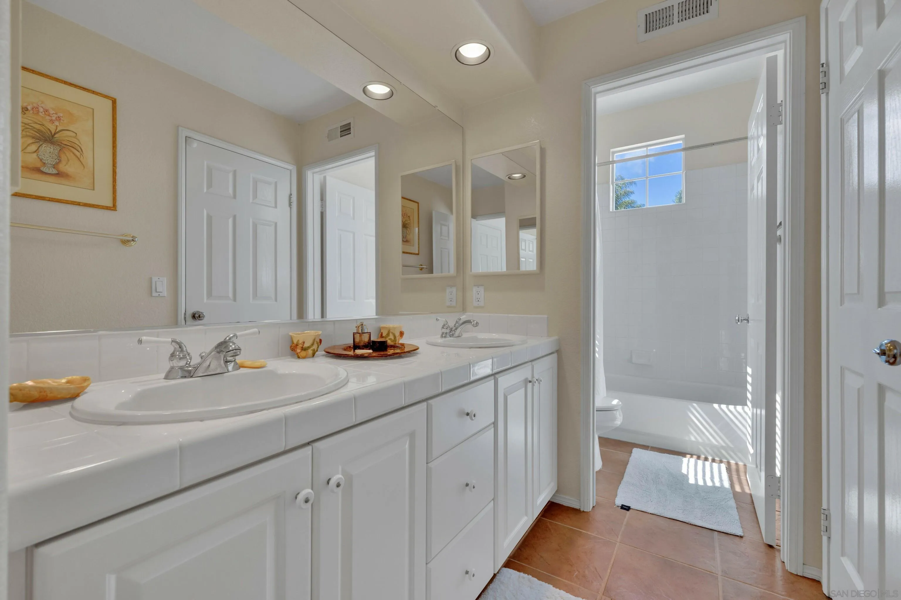 4967 Riding Ridge Road San Diego, CA 92130 - Photo 57 of 73 a bathroom with a sink and a mirror