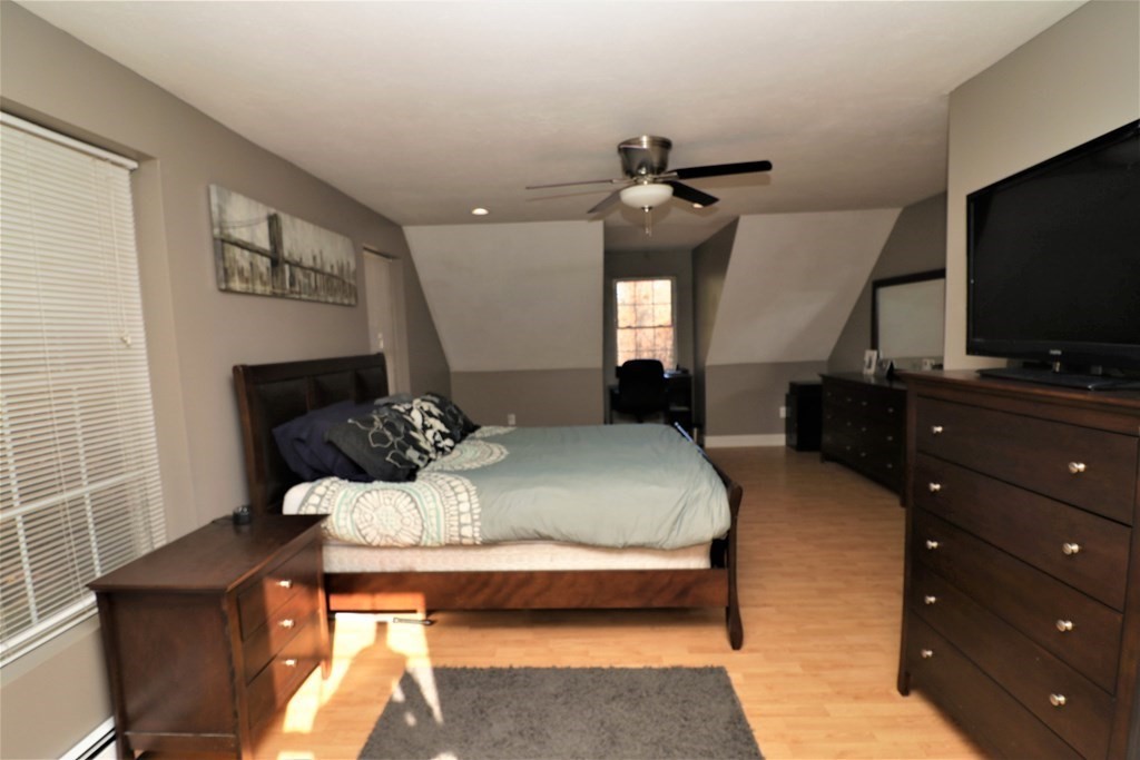 389 County Road Ashby, MA 01431 - Photo 21 of 34 a bedroom with a bed and a flat screen tv