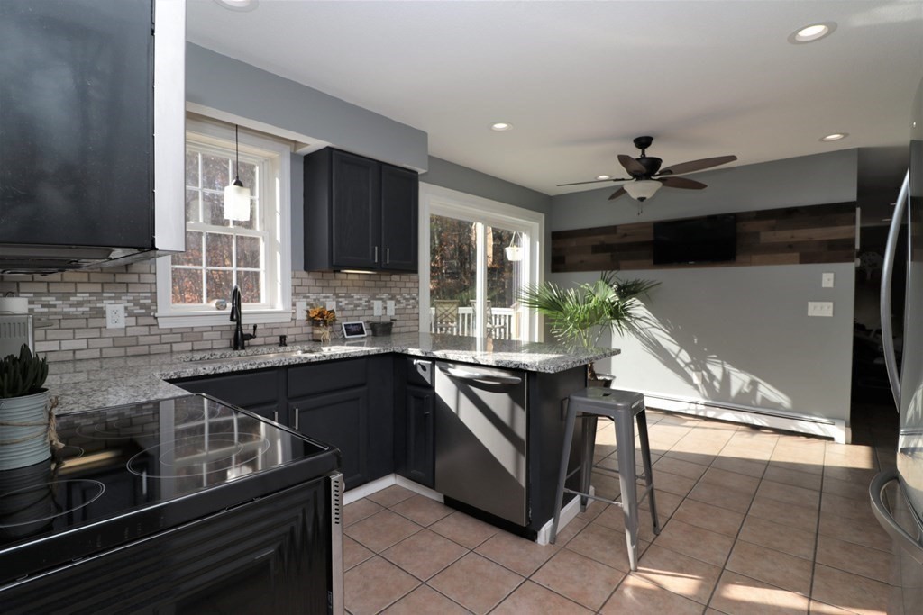 389 County Road Ashby, MA 01431 - Photo 5 of 34 a kitchen with kitchen island granite countertop a sink and a stove top oven with wooden floor