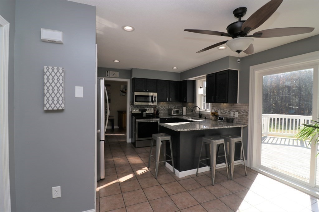 389 County Road Ashby, MA 01431 - Photo 7 of 34 a kitchen with stainless steel appliances granite countertop a sink and a refrigerator