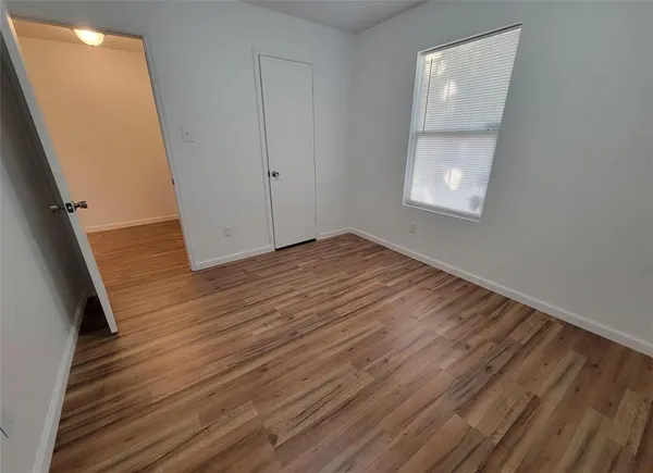 a view of a room with wooden floor and staircase