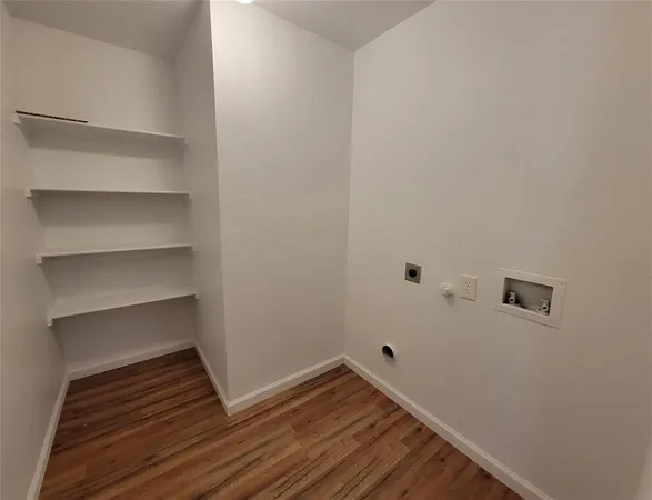 a view of a room with wooden floor