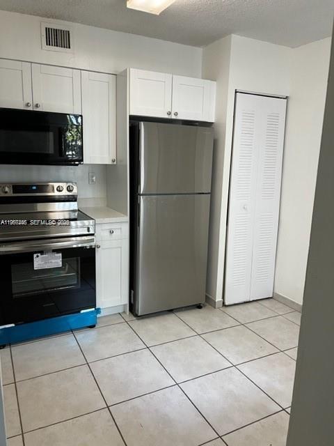 14020 Southwest 90th Terrace, Unit 14020 Miami, FL 33186 - Photo 1 of 13 a kitchen with a refrigerator a stove and a sink