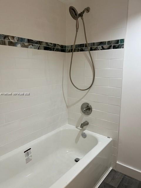 14020 Southwest 90th Terrace, Unit 14020 Miami, FL 33186 - Photo 4 of 13 a bathroom with a shower and a bath tub