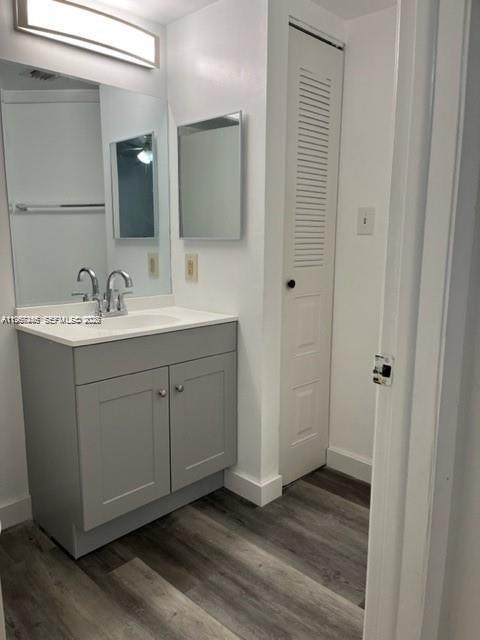 14020 Southwest 90th Terrace, Unit 14020 Miami, FL 33186 - Photo 7 of 13 a bathroom with a sink and a mirror