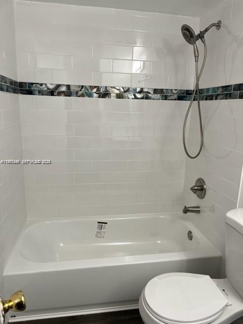 14020 Southwest 90th Terrace, Unit 14020 Miami, FL 33186 - Photo 8 of 13 a bathroom with a toilet and a bathtub