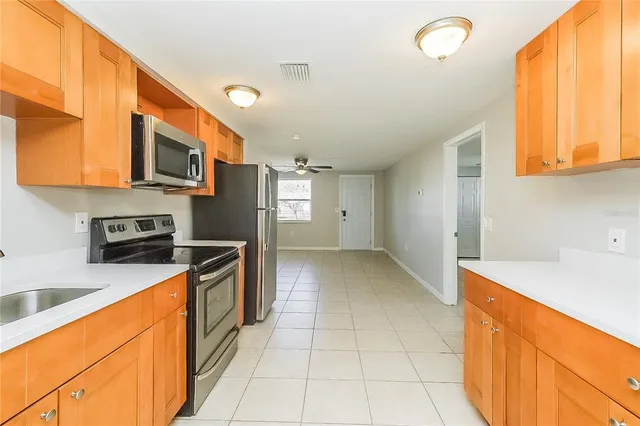 a kitchen with stainless steel appliances granite countertop a sink and cabinets
