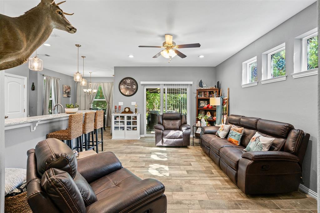 905 Poe Street Azle, TX 76020 - Photo 11 of 30 a living room with furniture and a large window