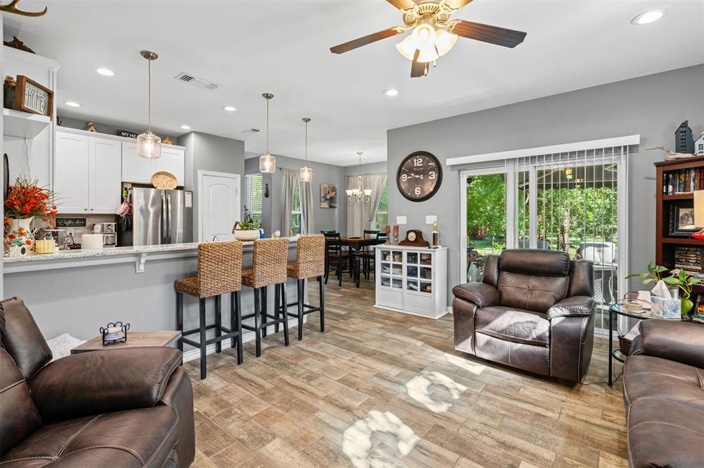 905 Poe Street Azle, TX 76020 - Photo 12 of 30 a living room with furniture and a large window