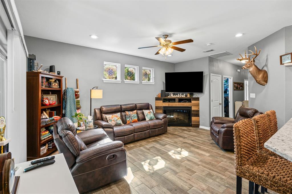 905 Poe Street Azle, TX 76020 - Photo 13 of 30 a living room with furniture and a flat screen tv