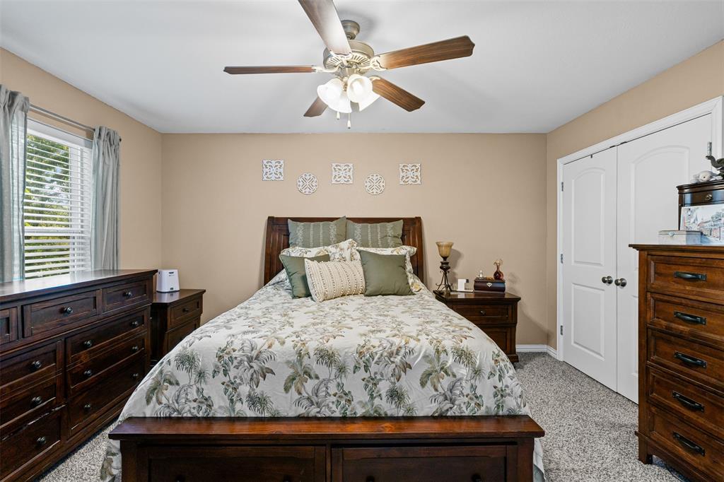 905 Poe Street Azle, TX 76020 - Photo 18 of 30 a bedroom with a bed and a dresser
