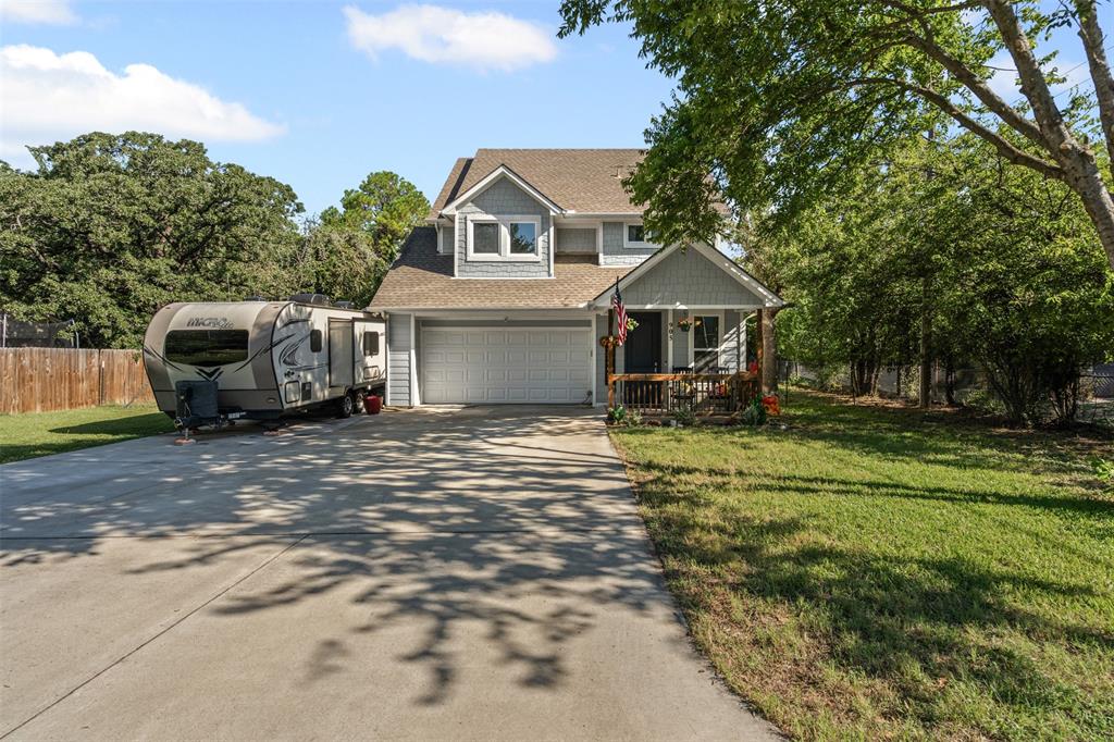 905 Poe Street Azle, TX 76020 - Photo 2 of 30 a front view of a house with a yard garage and outdoor seating