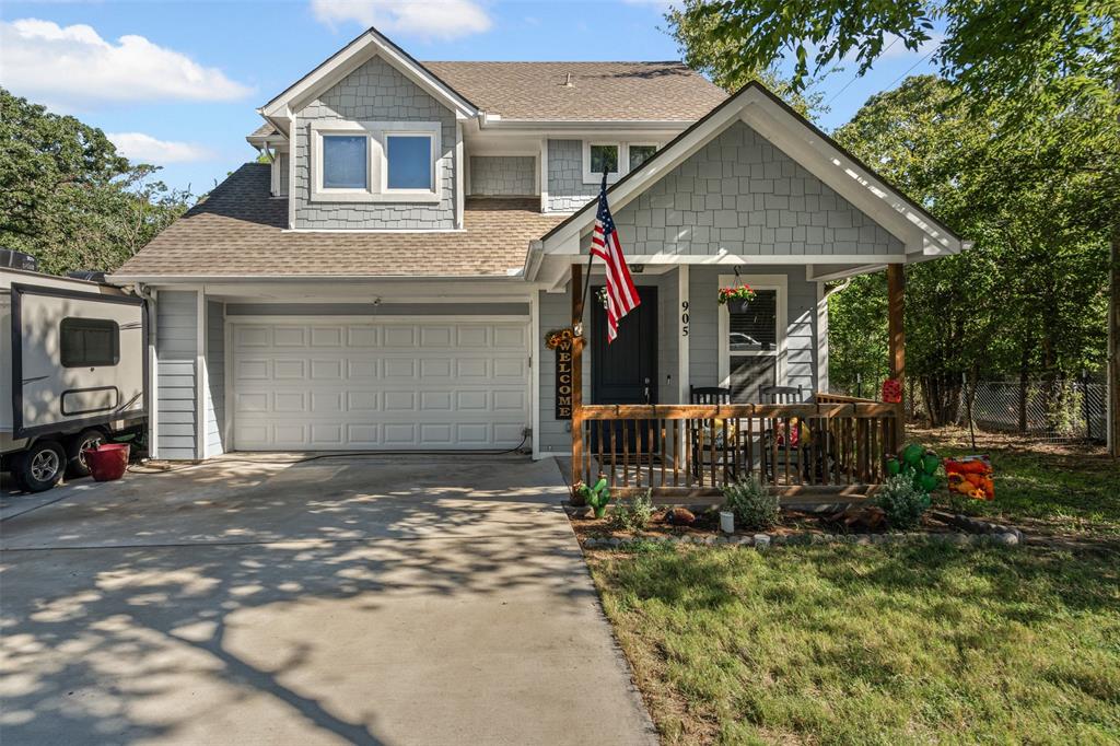 905 Poe Street Azle, TX 76020 - Photo 3 of 30 a front view of a house with garden