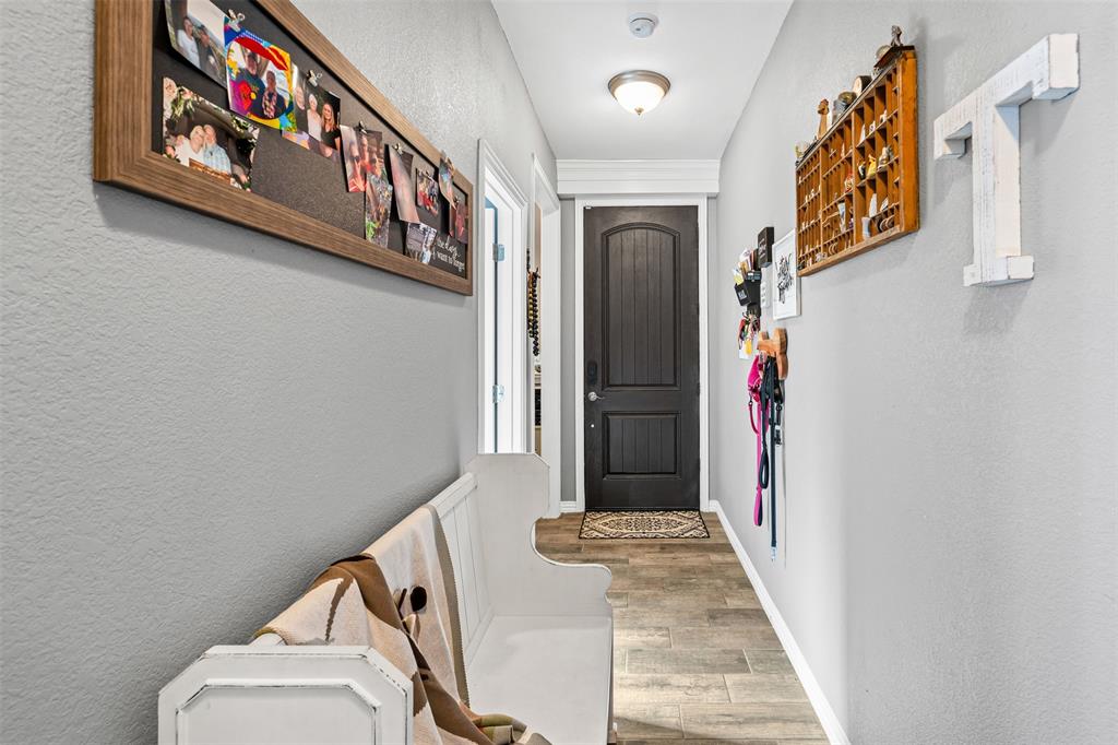 905 Poe Street Azle, TX 76020 - Photo 8 of 30 a view of a hallway with entryway and stairs