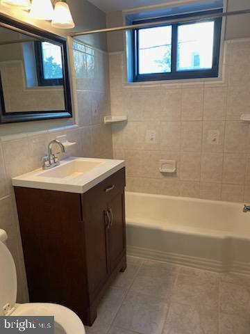 1200 South Arlington Ridge Road, Unit 411 Arlington, VA 22202 - Photo 4 of 9 a bathroom with a sink and a mirror