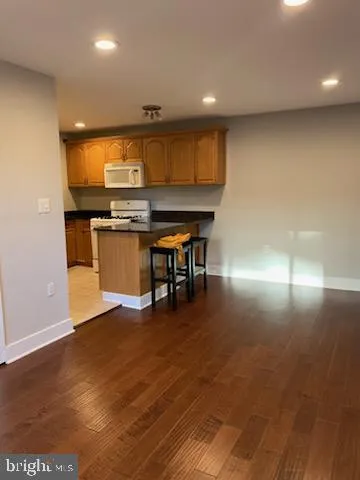 a room with wooden floor and pool table