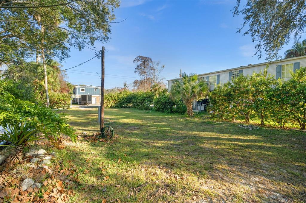 7287 Coventry Court Weeki Wachee, FL 34607 - Photo 13 of 16 a backyard of a house with lots of green space and fountain
