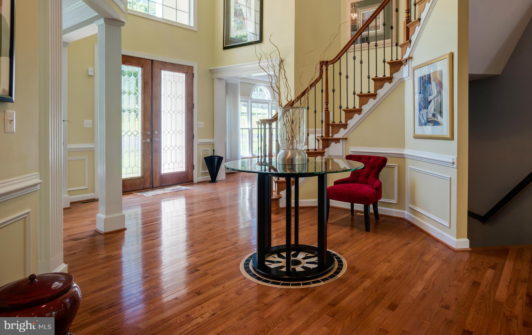 9755 Hawkins Creamery Road Laytonsville, MD 20882 - Photo 3 of 30 a view of a livingroom with furniture stairs and a fireplace