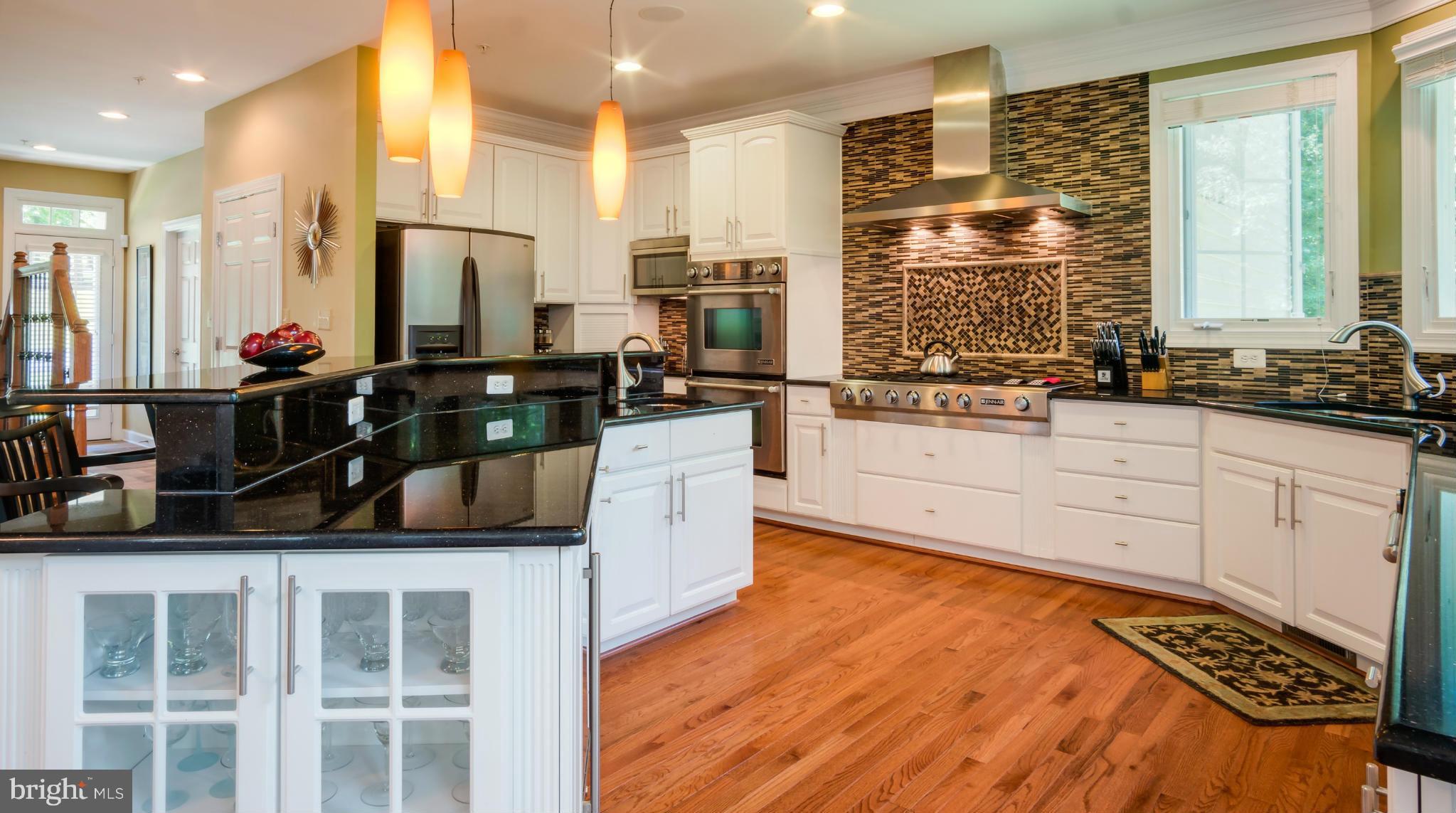 9755 Hawkins Creamery Road Laytonsville, MD 20882 - Photo 5 of 30 a kitchen with stainless steel appliances kitchen island granite countertop a stove a sink and a refrigerator