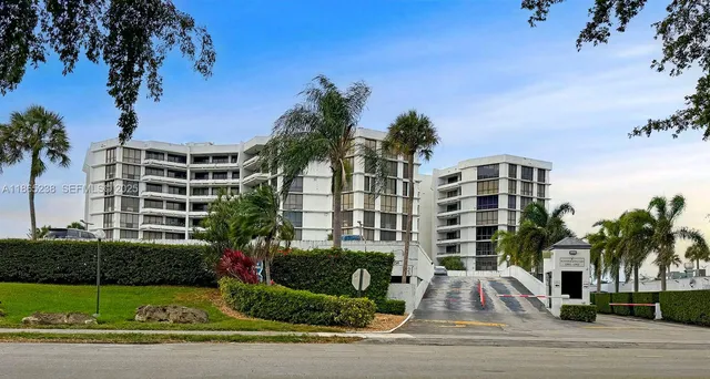 a view of a tall building next to a yard