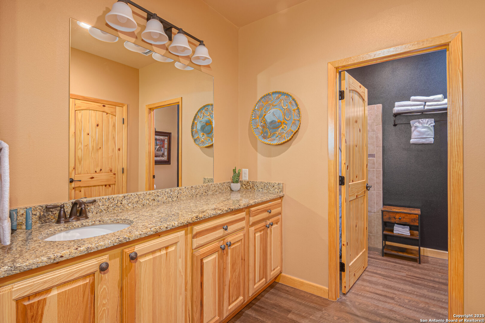 1554 Gruene Road, Unit A5 New Braunfels, TX 78130 - Photo 15 of 22 a bathroom with a granite countertop sink and a mirror