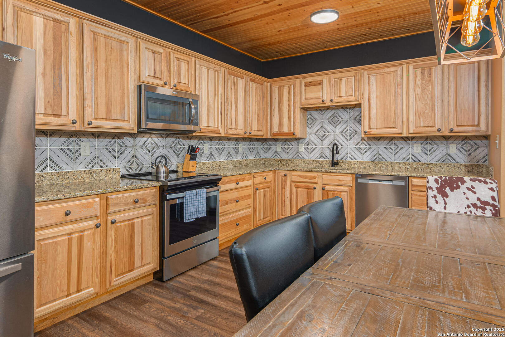 1554 Gruene Road, Unit A5 New Braunfels, TX 78130 - Photo 5 of 22 a kitchen with stainless steel appliances granite countertop a stove a sink dishwasher and a microwave oven with cabinets