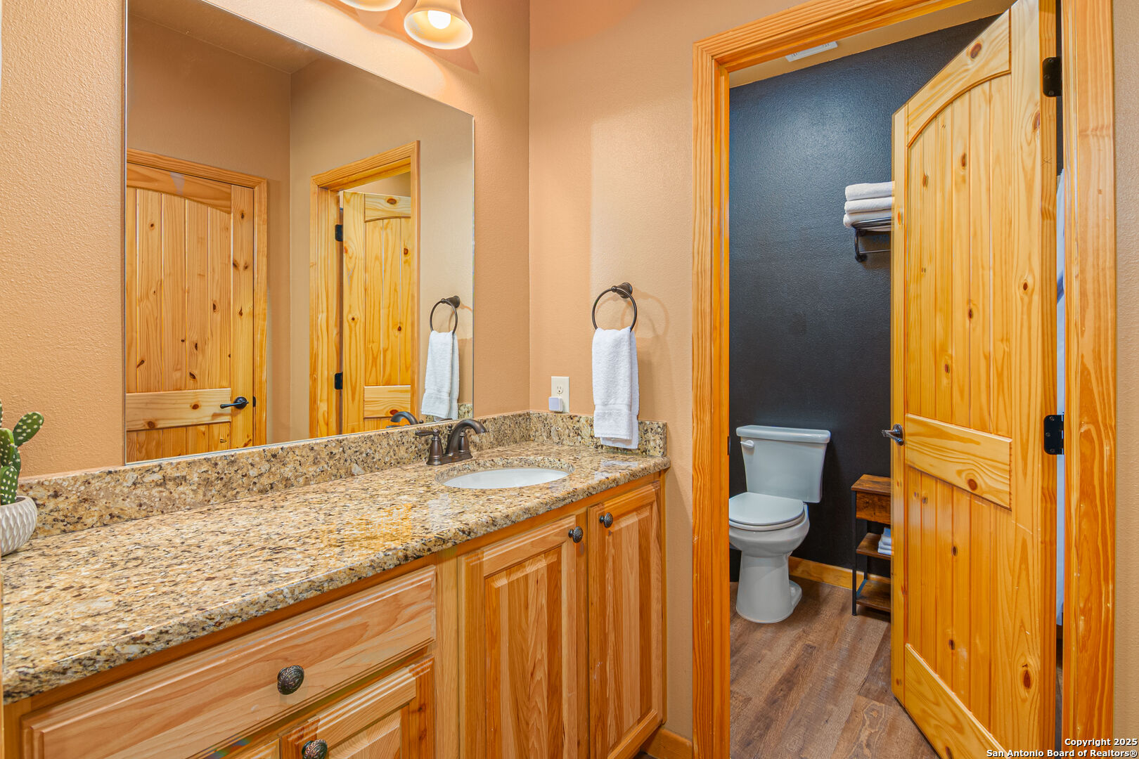 1554 Gruene Road, Unit A5 New Braunfels, TX 78130 - Photo 9 of 22 a bathroom with a granite countertop sink and a mirror