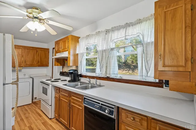 a kitchen with stainless steel appliances granite countertop a sink a stove and a refrigerator